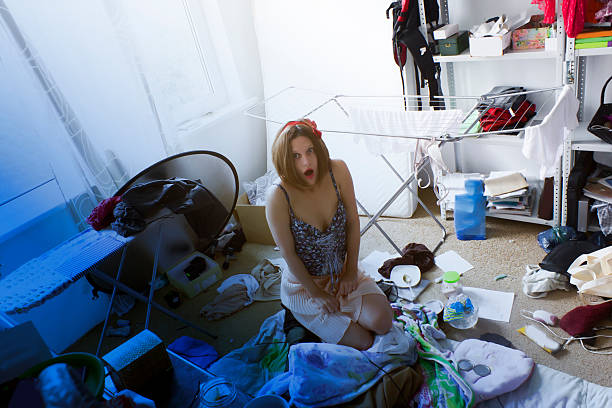 istock beautiful woman is expressing panic in her really messy room 499407139