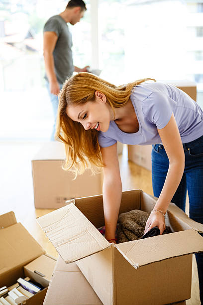 istock Young couple unpacking together and having fun 499418214