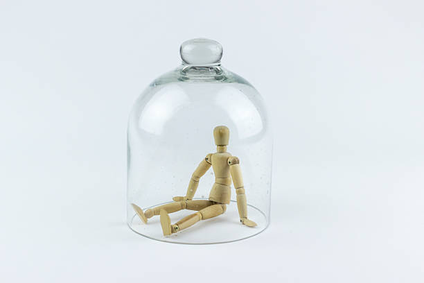 Wooden puppet in a glass bell