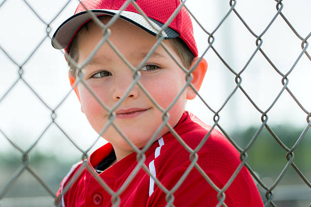 istock Baseball player wearing uniform sitting in dugout 499421351