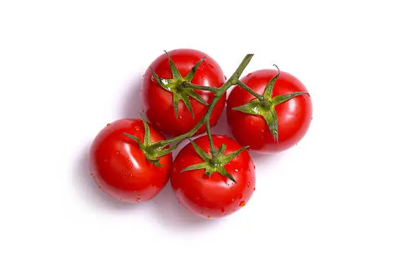Top view on bunch of fresh tomatoes, isolated on white background