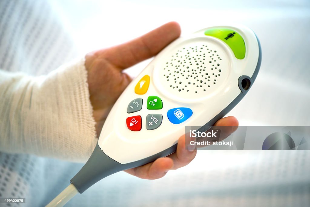 Hospital assistance remote control An isolated photo of hospital assistance remote control in patient's hand. Assistance Stock Photo