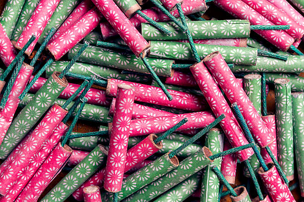 Firecracks Aerial view of a messy pile of different types of firecrackers. firework explosive material photos stock pictures, royalty-free photos & images