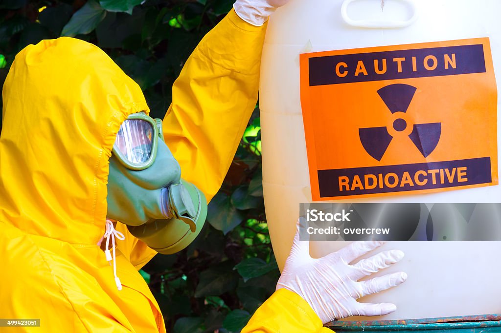 Radioactive waste Chemist with the gas mask and the protective suit the disposal of radioactive waste,photography Adult Stock Photo