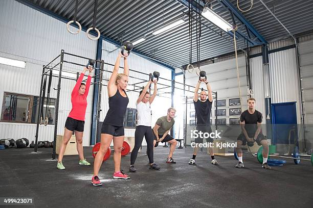 Team Workout With Kettlebells At Fitness Gym Stock Photo - Download Image Now - 20-29 Years, 30-39 Years, Active Lifestyle