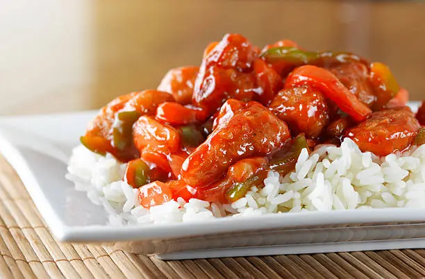 sweet and sour chicken on rice, shot up close
