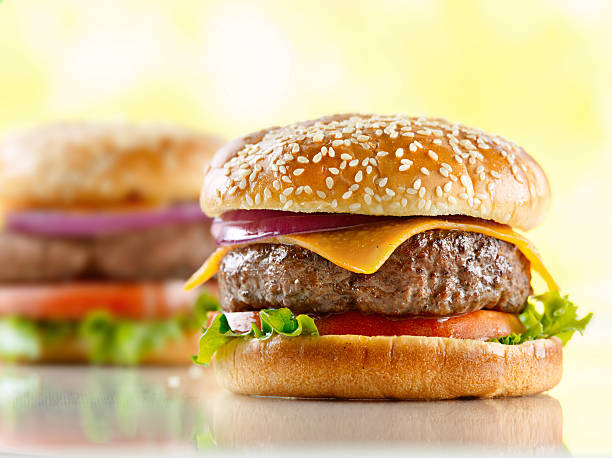 cheeseburgers - sesame bun american culture cheddar imagens e fotografias de stock