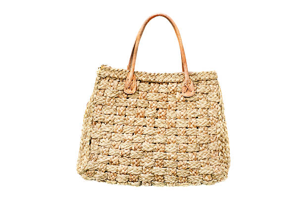 istock woman's handbag from natural straw isolated on white 499425975