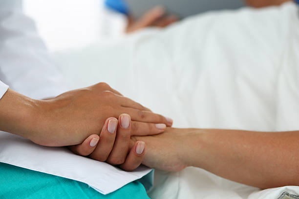 istock Friendly female doctor hands holding patient hand 499426776