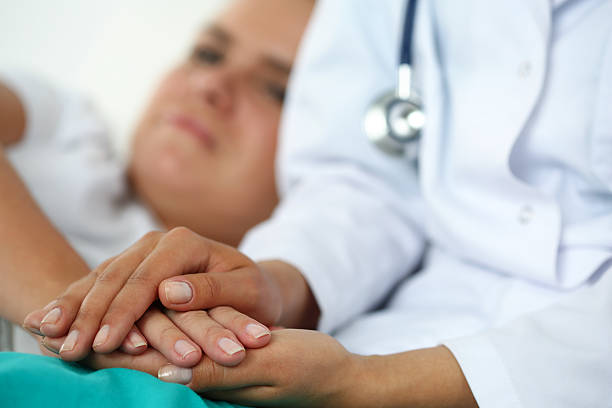 istock Friendly female doctor hands holding patient hand 499426946