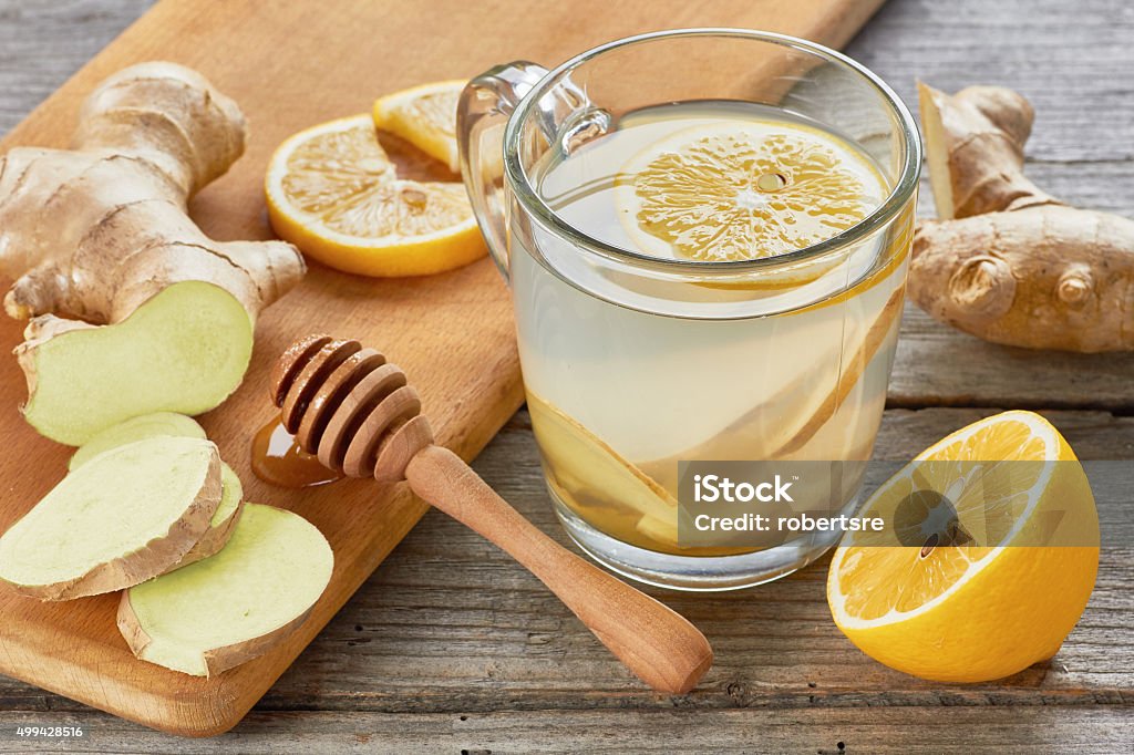 Ginger tee with lemon and honey on wooden table Ginger - Spice Stock Photo