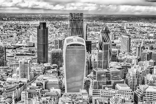 London Cityscape with the Canary Wharf business district and the river thames. The high angle image was captured during summer season.