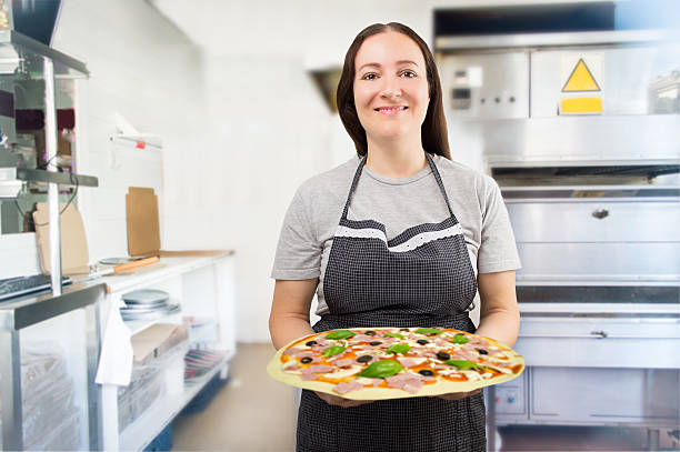 istock woman chef is cooking the pizza 499430410