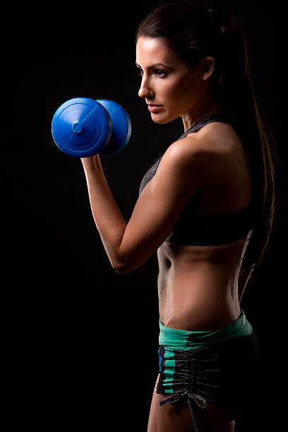 istock fitness woman on black background 499430456