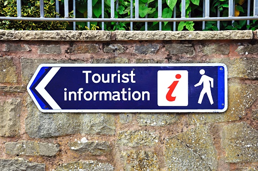 Blue tourist information on a stone wall, Leominster, Herefordshire, England, UK, Western Europe.