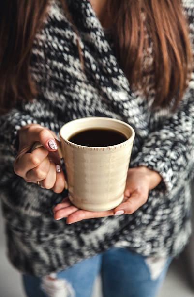istock Girl's hands holding cup of coffee 499432720