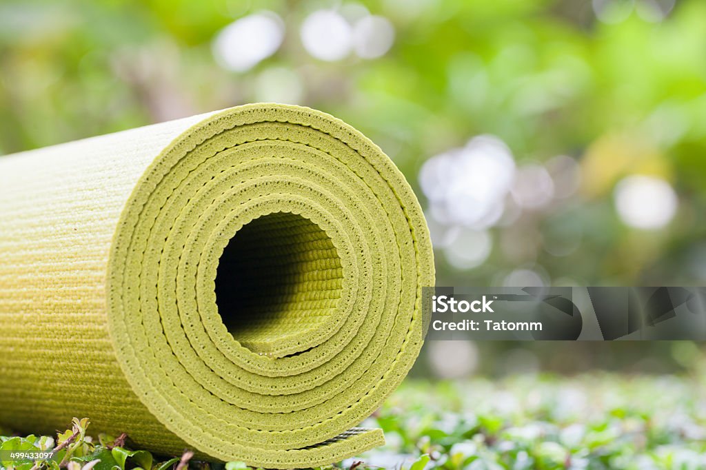 yoga mat A green yoga mat sets on grass Activity Stock Photo