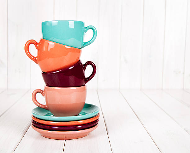 istock Colorful coffee cups on white wooden background 499433352