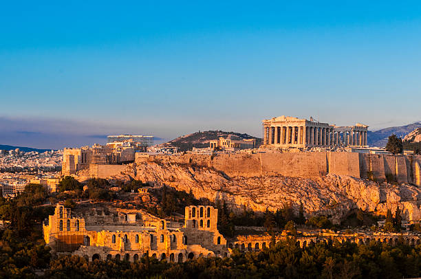 Acropolis Hill, Parthenon, Athens, Greece. Odeon Herodes Atticus. Golden Twilight. Acropolis, Parthenon and Theatre of Herodes Atticus, Athens, Greece. Golden late light. athens greece stock pictures, royalty-free photos & images