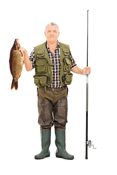 istock Fisherman holding a fish and fishing rod 499436049