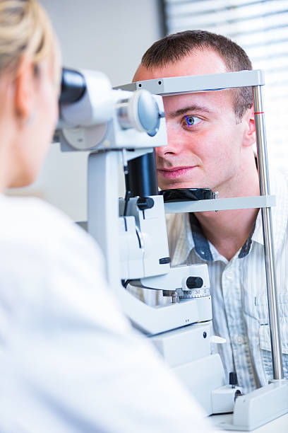 istock Young man having his eyes examined by optometrics 499436347