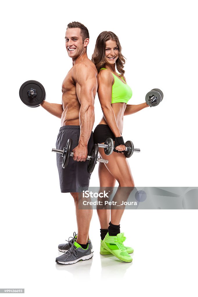 beautiful fitness young sporty couple with dumbbell beautiful fitness young sporty couple with dumbbell isolated over white background Abdominal Muscle Stock Photo