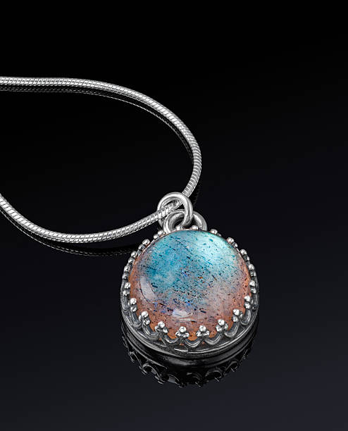 istock Round silver jewelry pendant on black background. 499437611