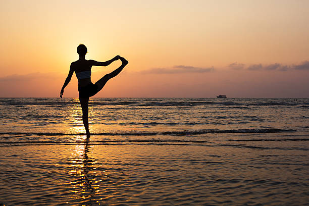 istock Yoga silhouette on the beach 499437865