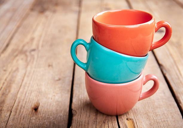 istock Colorful coffee cups on wooden table 499448424
