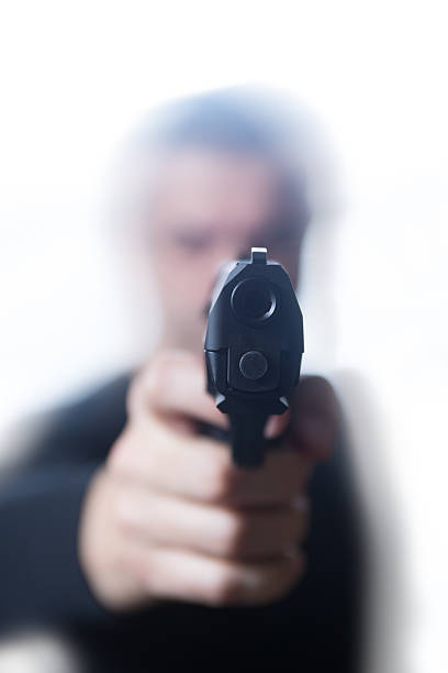 istock Man in black pointing handgun on White Background 499448724