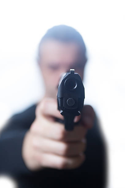 istock Man in black pointing handgun on White Background 499448894