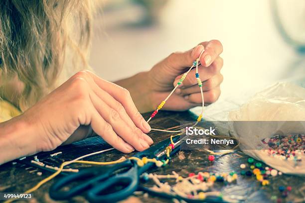 Girl Making Bracelet Of Colorful Beads Stock Photo - Download Image Now - Bracelet, Bead, Craft