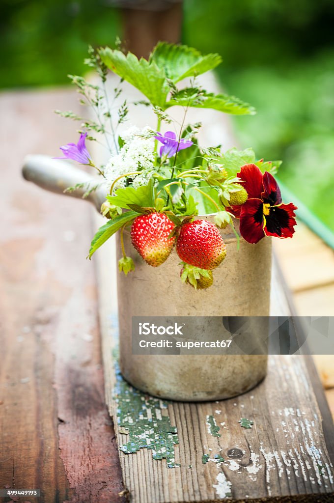 Summer bouquet Bouquet of  strawberries in rustic cup on a wooden background Dessert - Sweet Food Stock Photo