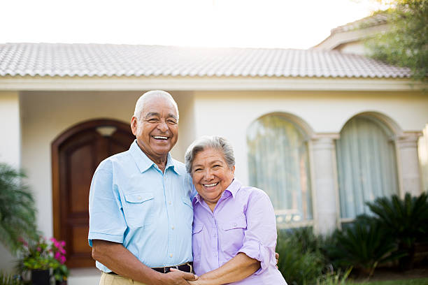 istock Senior couple in front of house 499449311