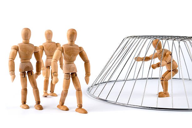 istock Wooden Mannequin isolated and trapped in a cage 499450485