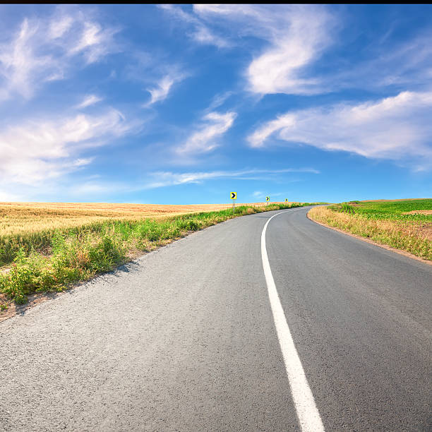 istock Driving on an empty asphalt road at sunny day 499451761