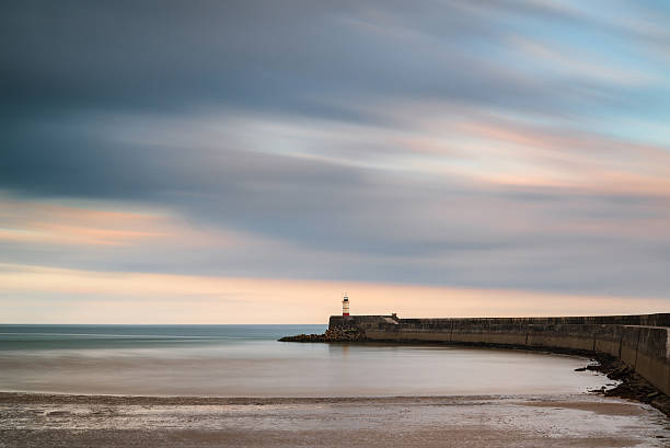 istock Stunning long exposure landscape lighthouse at sunset with calm 499452177