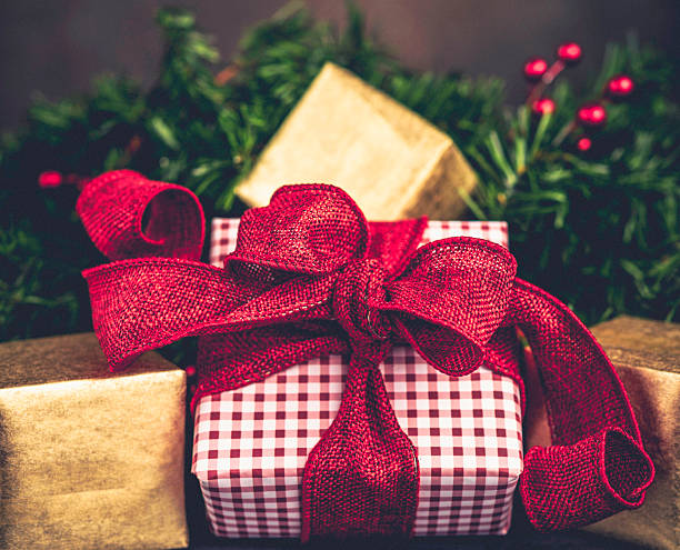 istock Christmas gifts with evergreen branches and berries 499452300