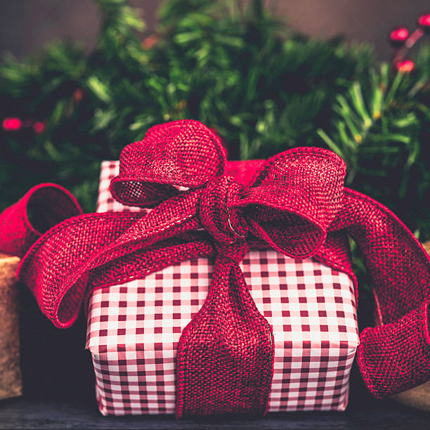 istock Christmas gift with evergreen branches and berries 499452336