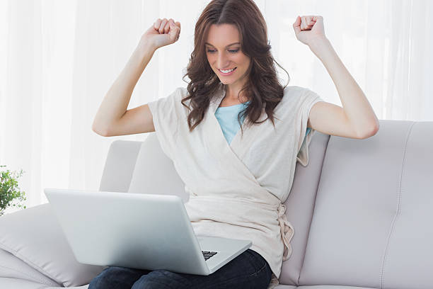 istock Overjoyed woman looking at her laptop 499452469