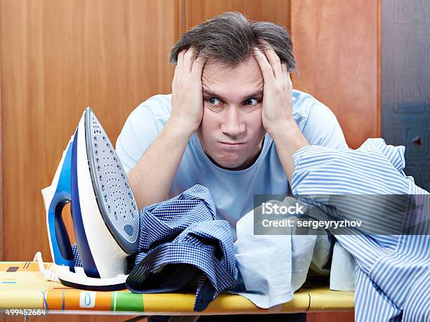 Sad Man With Pile Of Crumpled Shirts And Iron Stock Photo - Download Image Now - 2015, Activity, Adult
