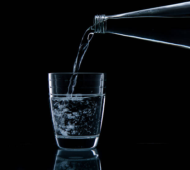 istock Pouring water on glass 499452723