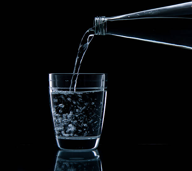 istock Pouring water on glass 499452727