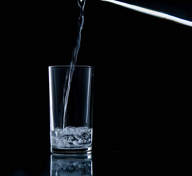 istock Pouring water on glass 499452735