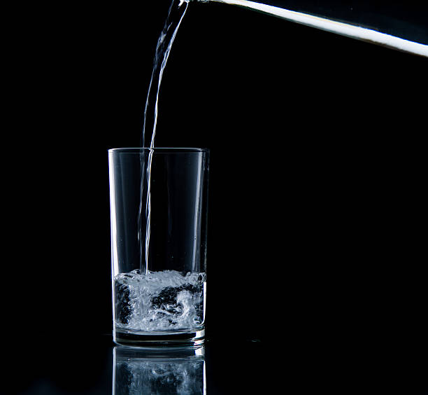 istock Pouring water on glass 499452739