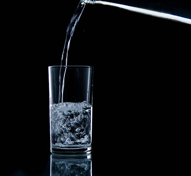 istock Pouring water on glass 499452747