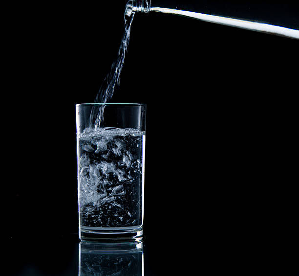 istock Pouring water on glass 499452775