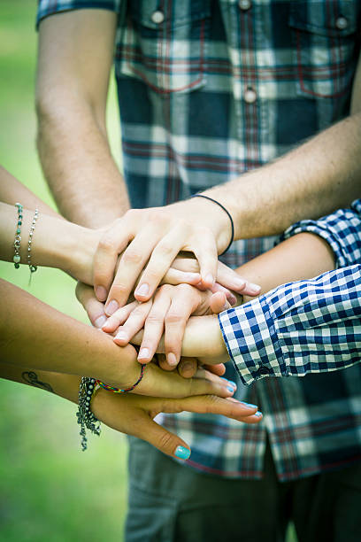 istock Group of friends joining hands 499452849