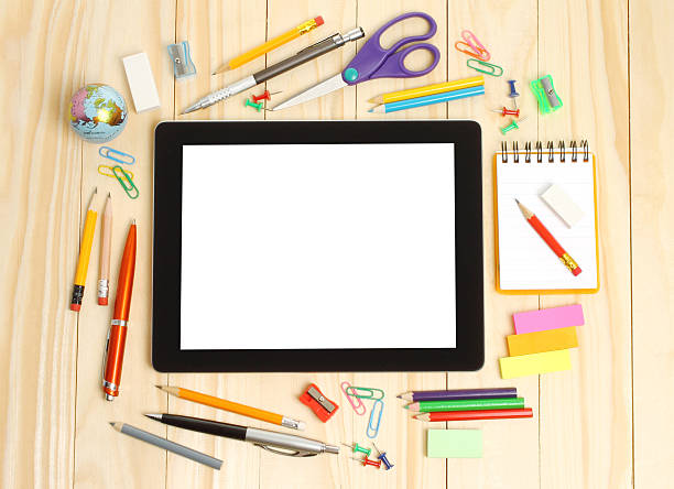 istock Tablet PC with school office supplies 499453173