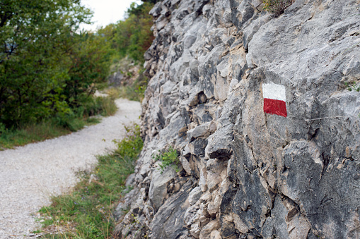 red-white mark on the rock on the mountain trail